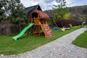 a playground with a slide and a play house at Zacisze Pod Śmielcem in Jagniątków