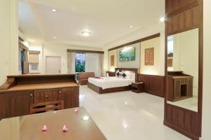 a large bedroom with a bed and a bathroom at Villa Wanida Garden Resort in North Pattaya