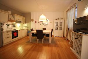 a kitchen with a table and chairs in a room at Romantic Apartment Pusta in Rovinj