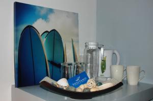 a shelf with a plate with a picture of surfboards at Positano Alona Beach Panglao in Panglao