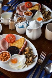 een tafel met borden ontbijtproducten erop bij The Fleece Inn in Haworth