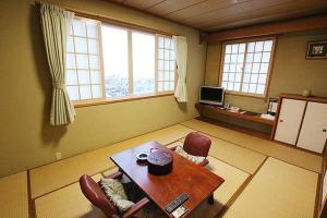 
a living room filled with furniture and a window at Hakodate Motomachi Hotel in Hakodate
