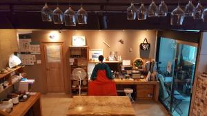 a woman in a room with a counter in a shop at Nearest Guesthouse in Jeonju