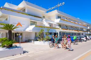 a group of people walking in front of a hotel at Hotel Montecristo in Marina di Campo
