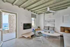 a living room with a couch and a table at Tourlos Bay Villas Mykonos in Tourlos