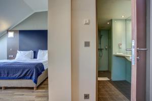 Postel nebo postele na pokoji v ubytování Hotel Orangerie