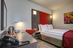 Postel nebo postele na pokoji v ubytování Hotel Orangerie