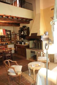 ガイオーレ・イン・キアンティにあるIl Fico in Chiantiの椅子とテーブル、キッチンが備わる客室です。