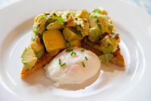 a plate of food with an egg and vegetables at Jeakes House in Rye