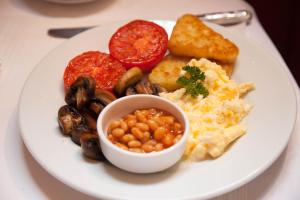a plate of breakfast food with eggs beans and toast at Jeakes House in Rye