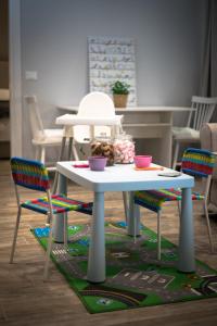 Laura Family Apartments في روما: طاولة بيضاء عليها كرسيين وصحنين