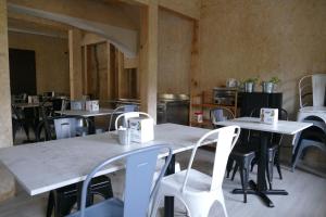 an empty restaurant with tables and white chairs at Hostería de Curtidores in Estella