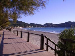 a beach with a fence next to the water at B&B Sita in Saint-Cyr-sur-Mer