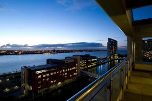 a view from the balcony of a building at night at Merchant Quarters Apartments in Liverpool