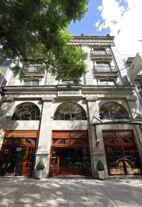 a building with many windows and doors on a street at Emporio Reforma in Mexico City