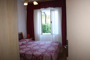 Postel nebo postele na pokoji v ubytování Apartments Sandra