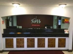 a lobby with a counter with a sign on it at GuestHouse Inn Dothan in Dothan