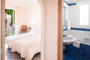 a hotel room with a bed and a sink at Hotel Continental Ischia in Ischia