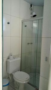 a bathroom with a toilet and a glass shower at Hotel Potencial in Conselheiro Lafaiete