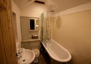 a bathroom with a sink and a tub and a toilet at Stoney Lane in Thaxted