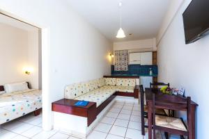 a living room with a couch and a table at Rosebay Apartments in Sfakaki