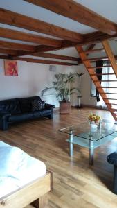 a living room with a couch and a glass table at NEUSTADT Villa in Braşov