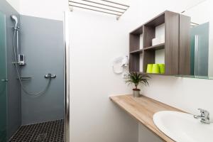a bathroom with a sink, toilet, and shower stall at Apartments Villa Luna in Vienna