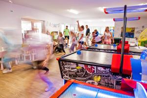a group of people playing games in a gym at Holiday Park & Resort Pobierowo - całodniowe animacje i podgrzewany basen w cenie in Pobierowo +38 photos