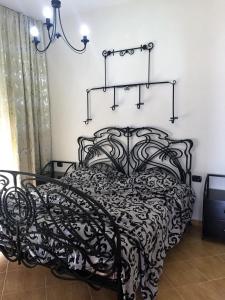 a black and white bed in a room at Royal King and Queen apartment for Luxury Life in Sarandë