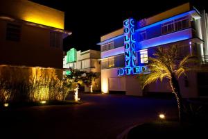 a hotel with a neon sign on the side of it at Miami Motel ( ADULT ONLY ) in Pindamonhangaba