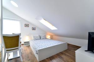 En eller flere senge i et værelse på Piccolo Apartments