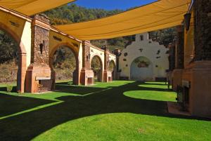an outdoor pavilion with a yellow canopy and green grass at Sierra Lago in La Laguna