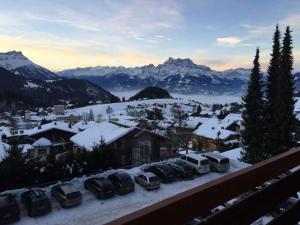 a group of cars parked in a parking lot in the snow at Apartment Leysin - Swiss Alps - Fully Renovated ! in Leysin