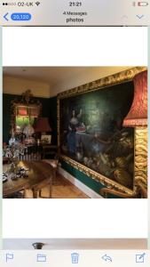 a living room with a large painting on the wall at 10 st james villas in Winchester