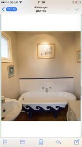 a bathroom with a tub and a sink at 10 st james villas in Winchester