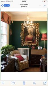 a living room with a painting of a woman on the wall at 10 st james villas in Winchester