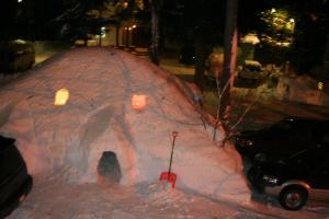 un igloo de neige sur le côté d'une rue la nuit dans l'établissement B&B Santana Hakuba, à Hakuba