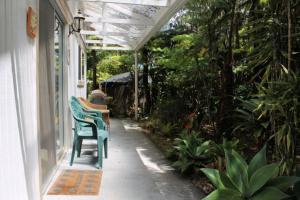 a porch with a green chair on a house at Country Goose in Volcano