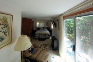 a living room with a couch and a room with a bedroom at Country Goose in Volcano +4 photos