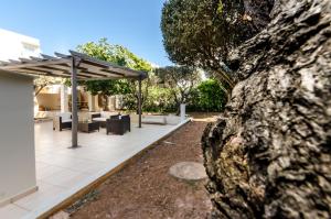 a patio with a table and chairs and a canopy at Aquarius - Glyfada detached house in Athens