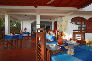 a dining room with a table with blue table cloth at Haus am Meer "Wilde Ananas" in Koggala