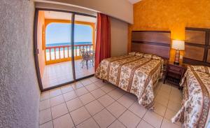 Säng eller sängar i ett rum på Hotel Playa Del Sol