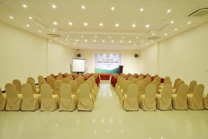 a room with chairs and a screen with a presentation at Bamboo Green Riverside Hotel in Danang