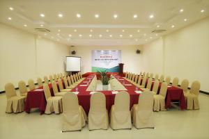 a conference room with a long table and chairs at Bamboo Green Riverside Hotel in Danang