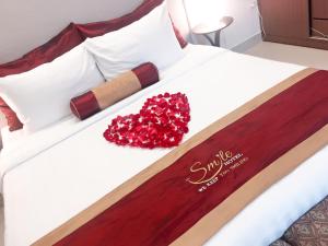 Ένα ή περισσότερα κρεβάτια σε δωμάτιο στο Smile Hotel