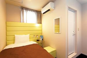 Ein Bett oder Betten in einem Zimmer der Unterkunft Hotel Iwaki