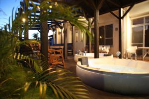 a large bath tub in the middle of a patio at Kerama Terrace in Tokashiki
