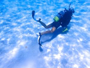 a man is swimming in the water in the ocean at Kerama Terrace in Tokashiki