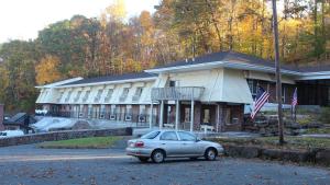 a car parked in front of a building at Passport Inn and Suites - Middletown in Middletown