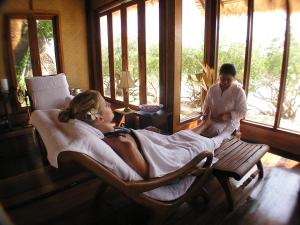 a woman laying in a bed in a chair in a room at Sarikantang Resort & Spa, Koh Phangan in Haad Rin